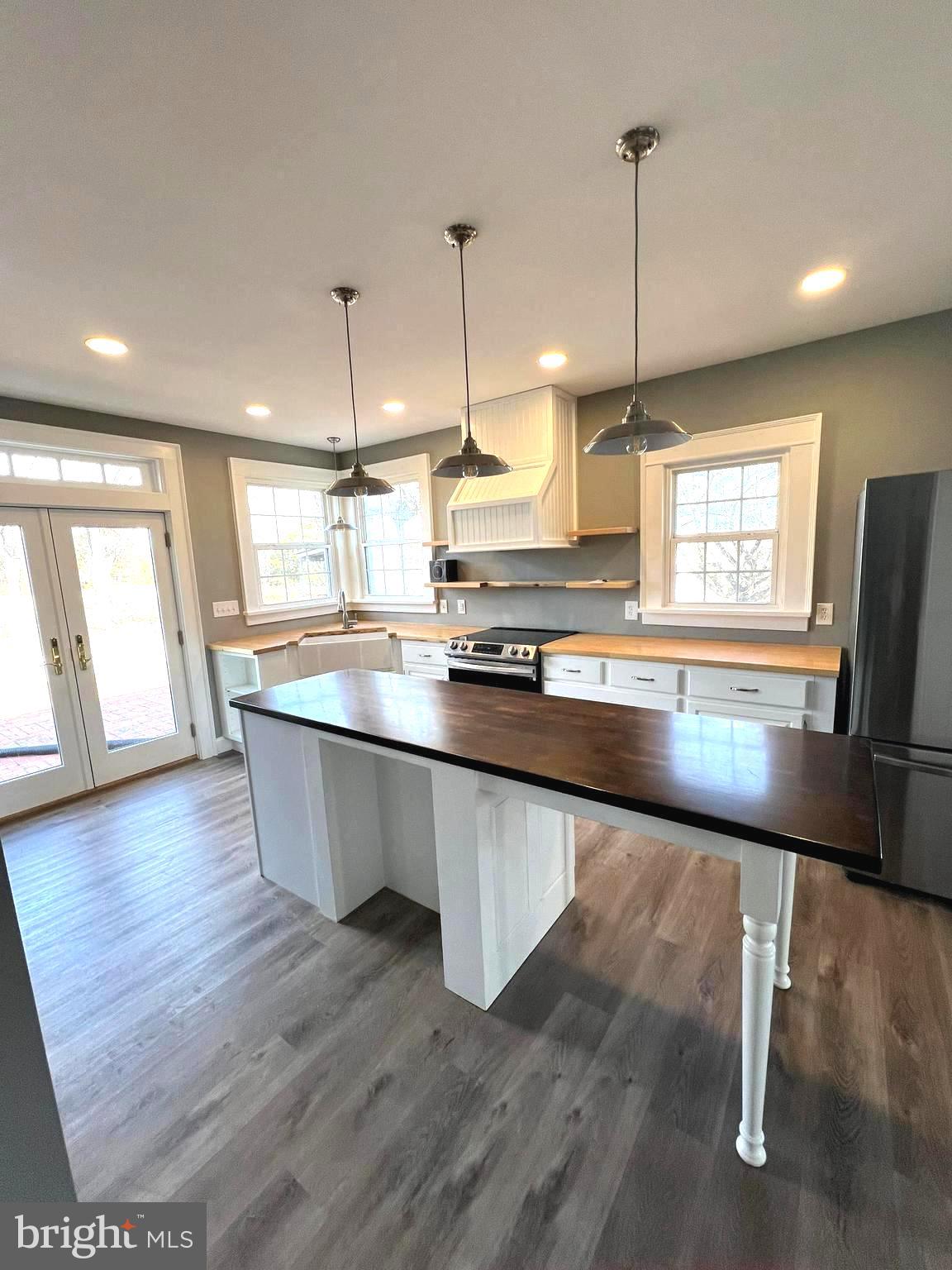 7617 Old Plank Road Fredericksburg, VA 22407 - Photo 8 of 61 a room with stainless steel appliances kitchen island granite countertop a stove a sink and a wooden floors