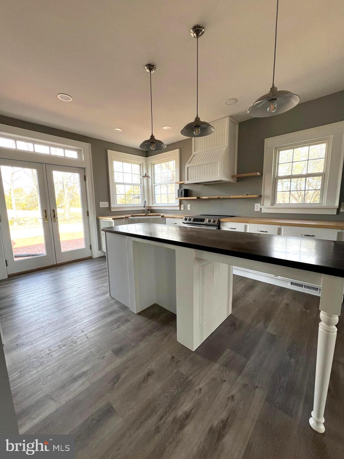 7617 Old Plank Road Fredericksburg, VA 22407 - Photo 9 of 61 a kitchen with stainless steel appliances granite countertop a sink a window and wooden floor