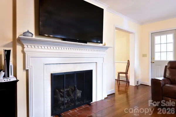a living room with a fireplace and a flat screen tv