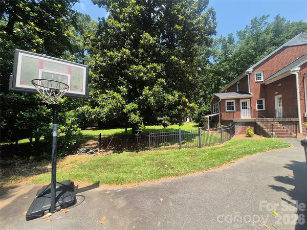 a view of a house with a yard and a patio