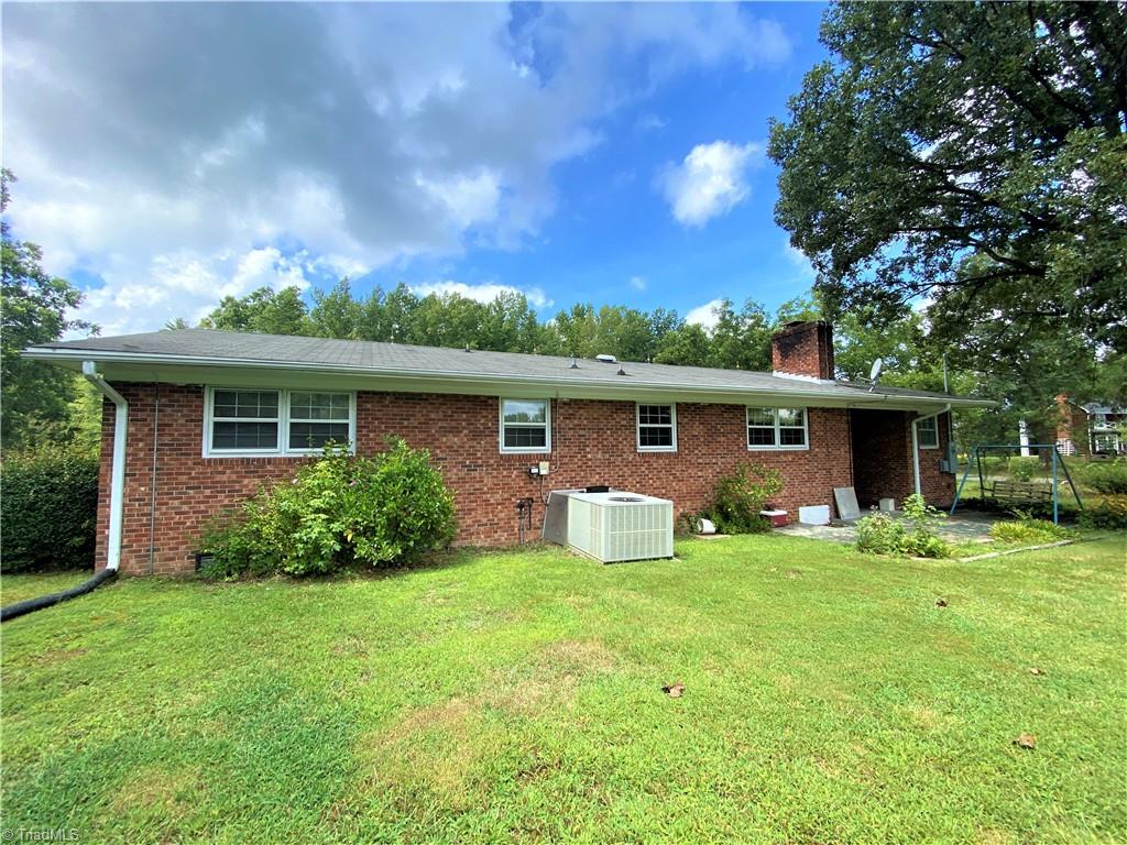 6603 Company Mill Road Climax, NC 27233 - Photo 16 of 24 At the back of the house, note the concrete patio and the combo propane gas and AC unit.