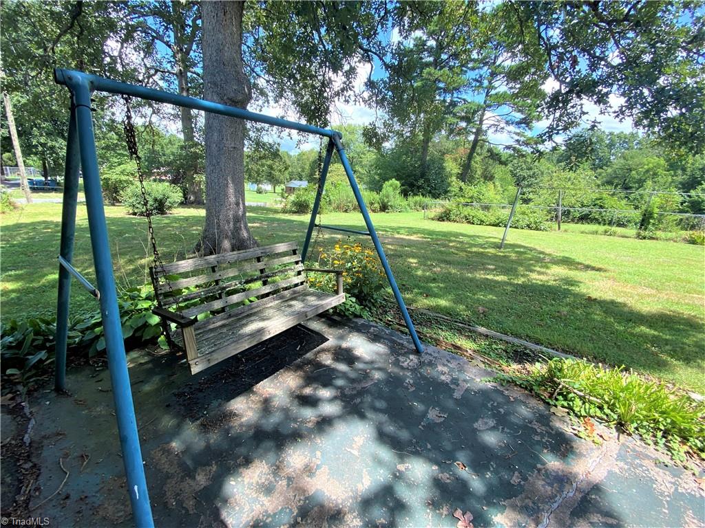 6603 Company Mill Road Climax, NC 27233 - Photo 17 of 24 Wow, how great would it be to sit on the back patio porch swing and look out to over 2 acres of land.