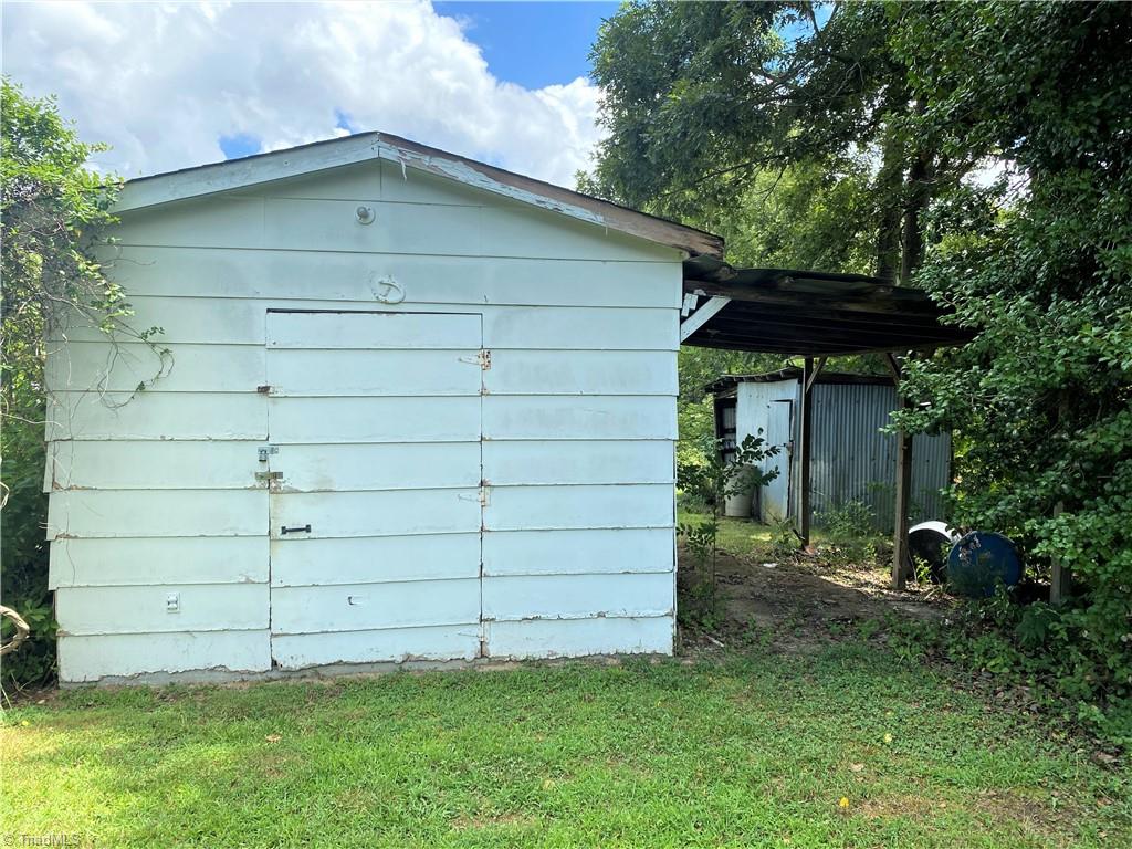 6603 Company Mill Road Climax, NC 27233 - Photo 20 of 24 Here is a large white outbuilding.