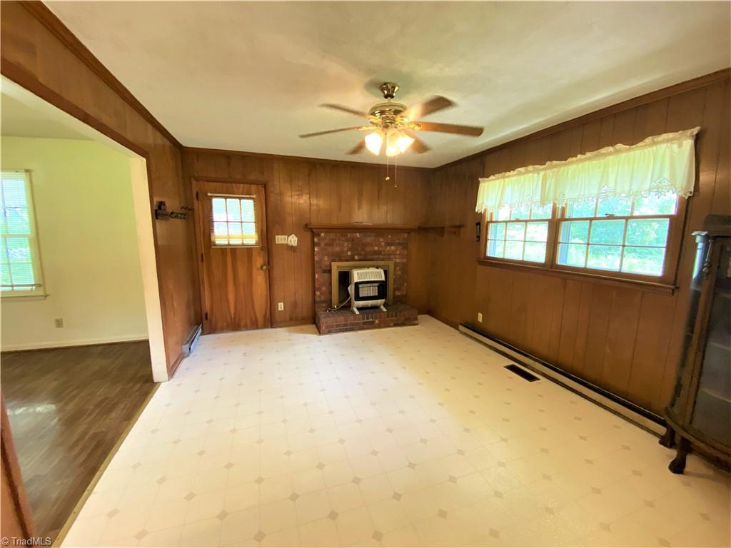 6603 Company Mill Road Climax, NC 27233 - Photo 4 of 24 The living room opens to the den. Notice the fireplace with a propane burning heater. There is also baseboard heat and a central forced warm air heat system fueled from propane and central air conditioning.