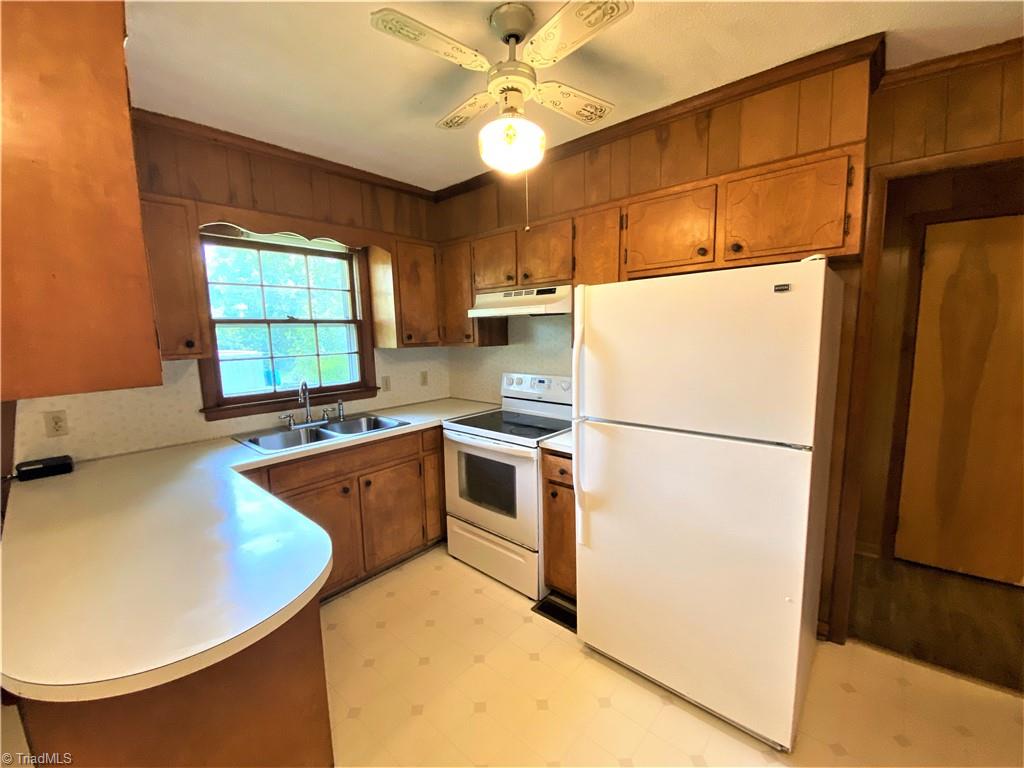 6603 Company Mill Road Climax, NC 27233 - Photo 5 of 24 Here are the natural finished wood cabinets in the kitchen. There is also a good sized refrigerator, smooth top electric range and hood. It opens to the den area