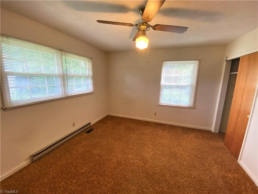 6603 Company Mill Road Climax, NC 27233 - Photo 6 of 24 This is the primary bedroom. Equipped with a ceiling fan and 3 windows flooding the room with light.