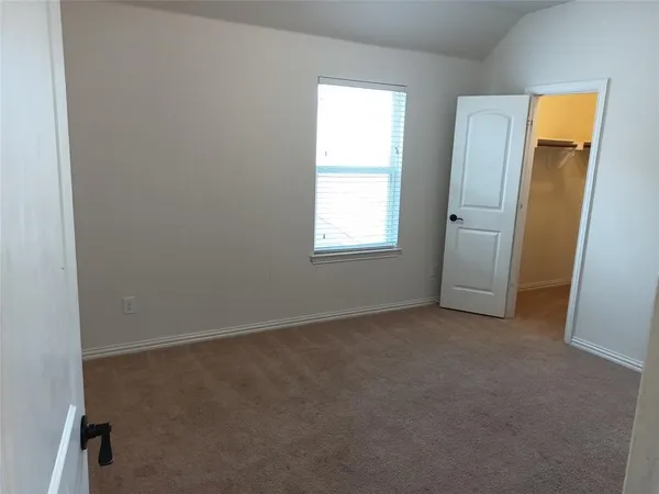 an empty room with windows and closet