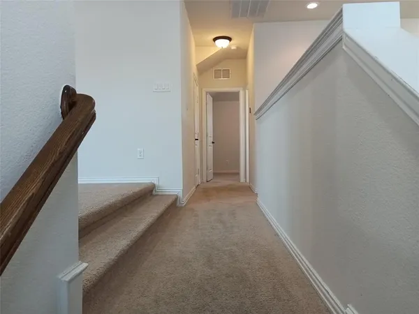 a view of a hallway with stairs