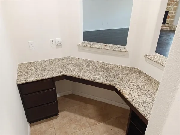 a living room with a rug and a wooden floor