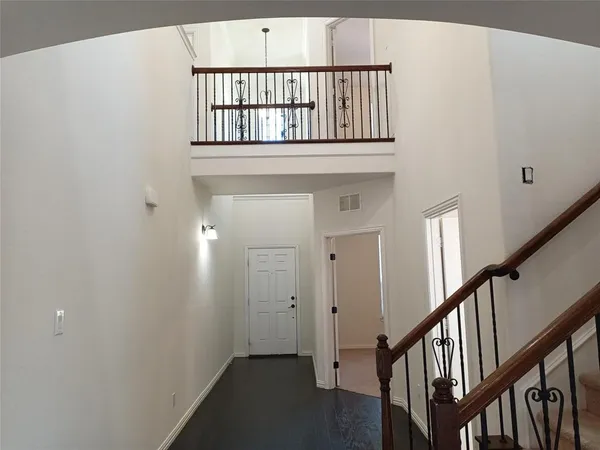 a view of staircase with white walls and a window
