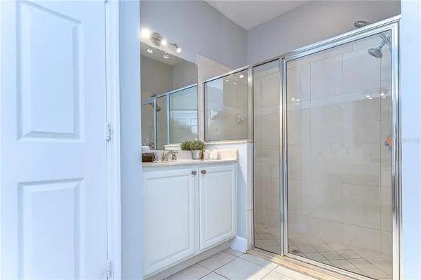 a bathroom with a shower and a sink