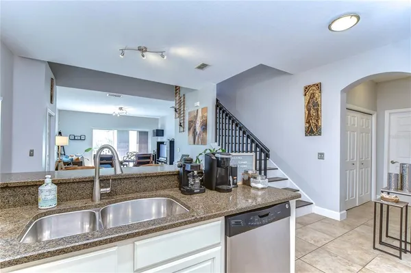 a kitchen with sink and refrigerator