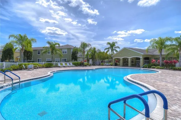 a view of swimming pool with outdoor seating and yard in back