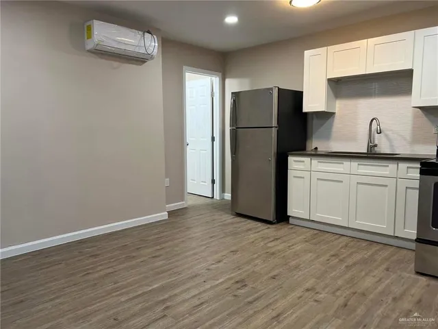 a kitchen with a refrigerator and a sink