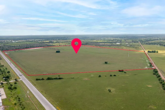 an aerial view of a residential houses with outdoor space
