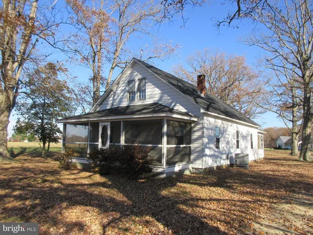 a view of a house with a yard covered in snow