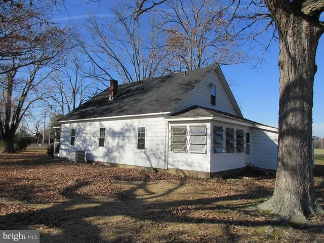 a view of a house with a yard covered with snow