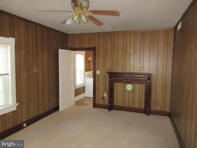 an empty room with closet and windows
