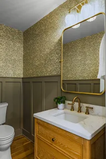 a bathroom with a sink vanity and a mirror