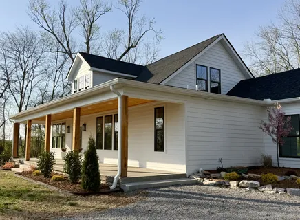 a living room with furniture a large window and a fireplace