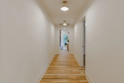 an empty room with a window and a ceiling fan