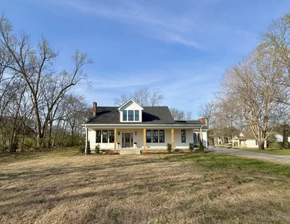 a kitchen with a table chairs sink and cabinets