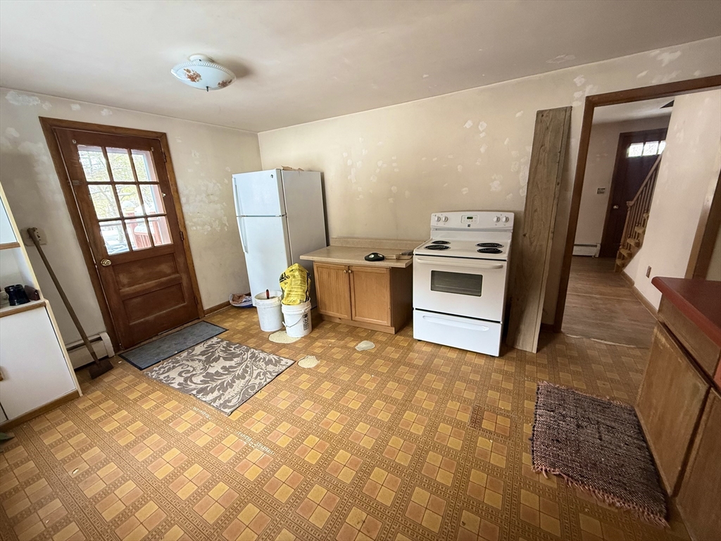 58 Arnold Road Sturbridge, MA 01518 - Photo 6 of 25 a kitchen with a stove a sink and a refrigerator
