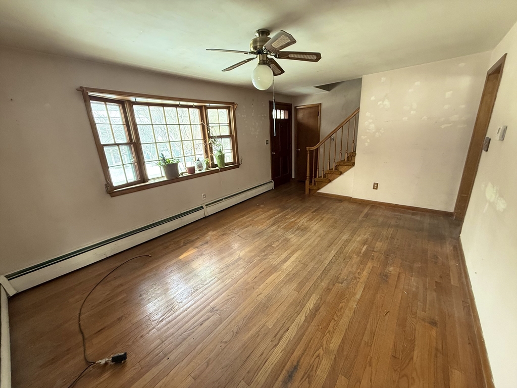 58 Arnold Road Sturbridge, MA 01518 - Photo 8 of 25 a view of an empty room with a window and wooden floor