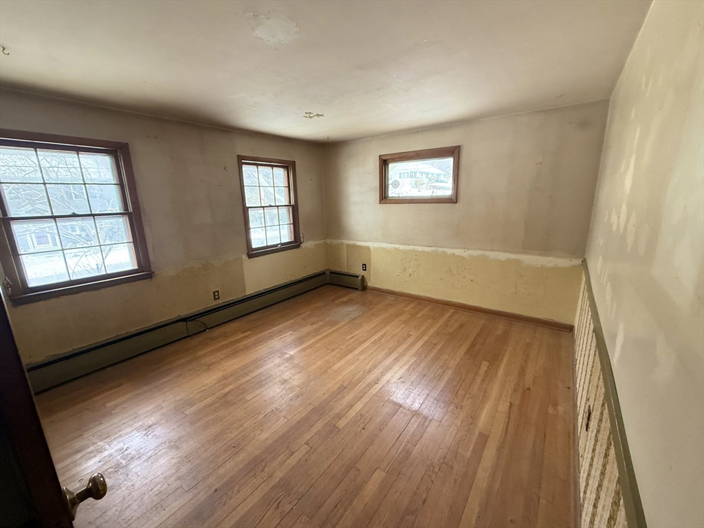 58 Arnold Road Sturbridge, MA 01518 - Photo 10 of 25 a view of an empty room with wooden floor and a window
