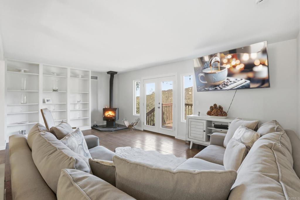 3340 Skytrail Ranch Road Jamul, CA 91935 - Photo 15 of 42 a living room with furniture and a fireplace