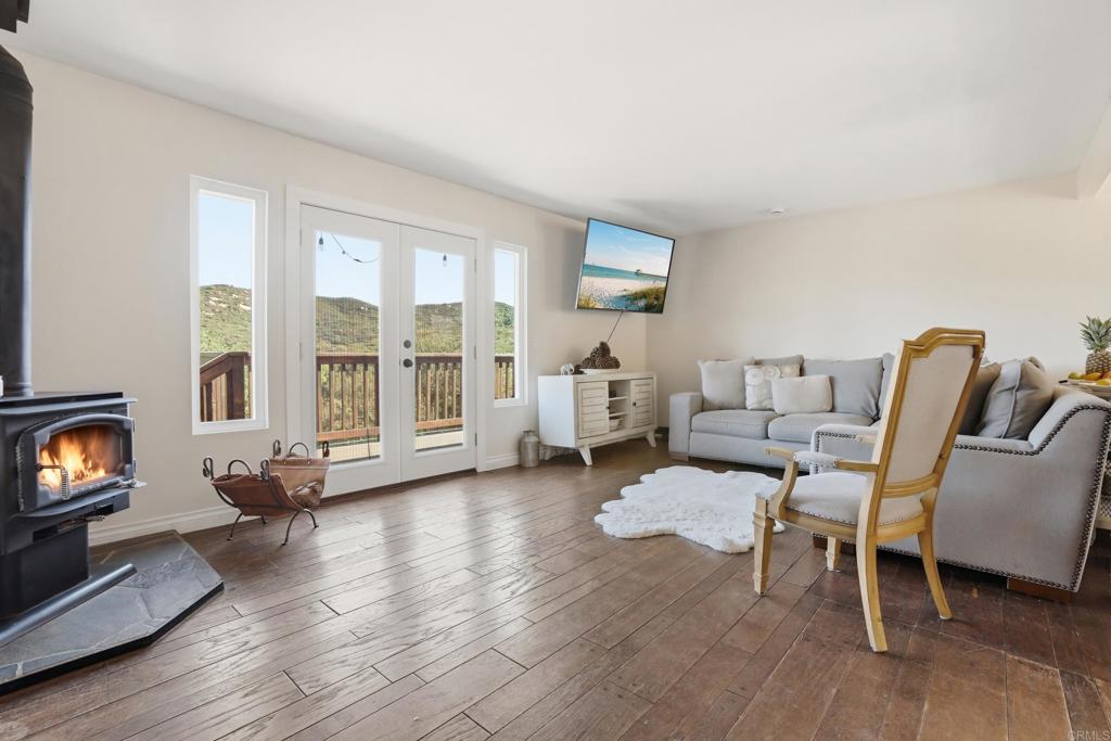 3340 Skytrail Ranch Road Jamul, CA 91935 - Photo 18 of 42 a living room with furniture and a fireplace