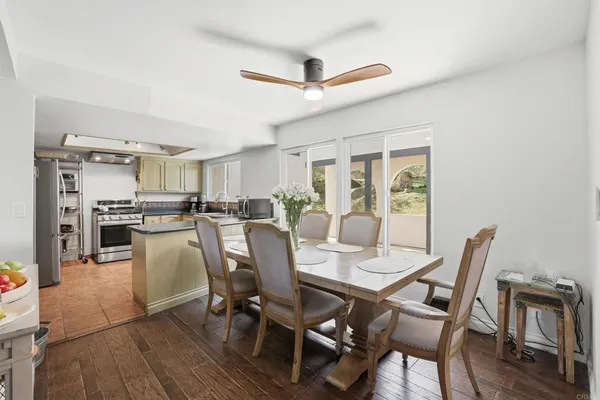 a dining room with furniture and a potted plant