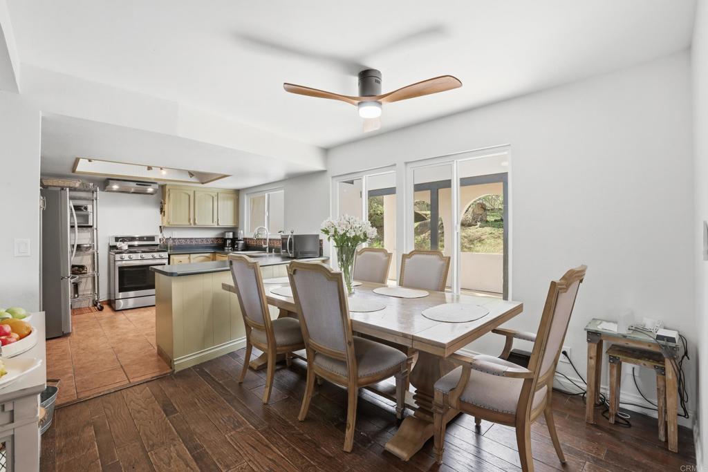 3340 Skytrail Ranch Road Jamul, CA 91935 - Photo 22 of 42 a view of a dining room with furniture and wooden floor