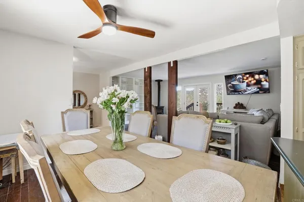 a spacious bedroom with a bed and a flat tv screen on dresser