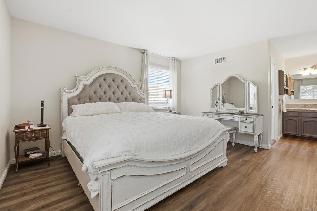3340 Skytrail Ranch Road Jamul, CA 91935 - Photo 24 of 42 a spacious bedroom with a bed and a flat tv screen on dresser