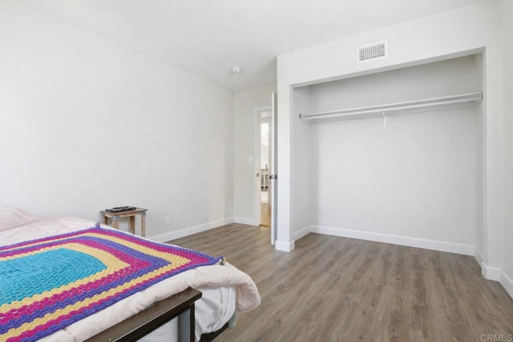 3340 Skytrail Ranch Road Jamul, CA 91935 - Photo 27 of 42 a room with a bed and a wooden floor