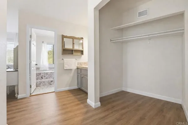 a bathroom with a granite countertop sink and mirror