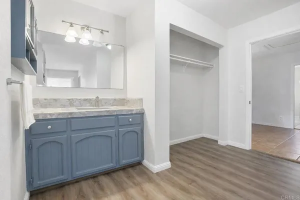a bathroom with a granite countertop sink a toilet and mirror