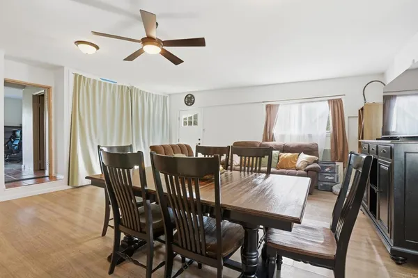 a living room with furniture a window and kitchen view