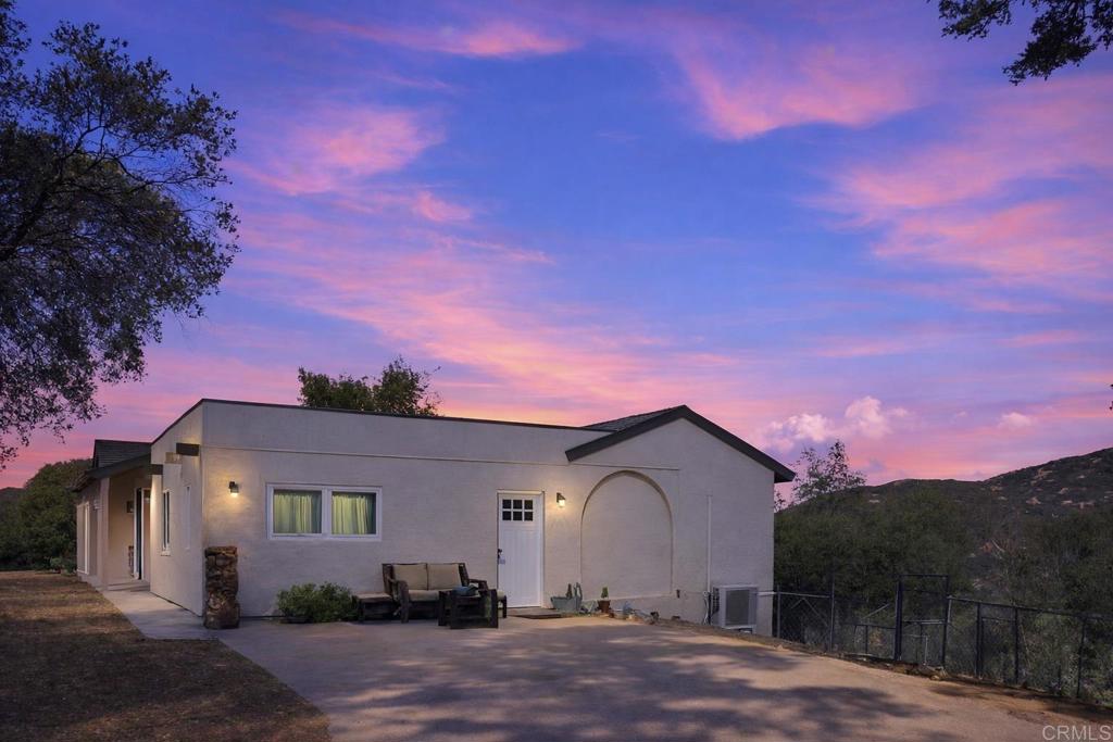 3340 Skytrail Ranch Road Jamul, CA 91935 - Photo 8 of 42 a front view of a house with a yard and garage