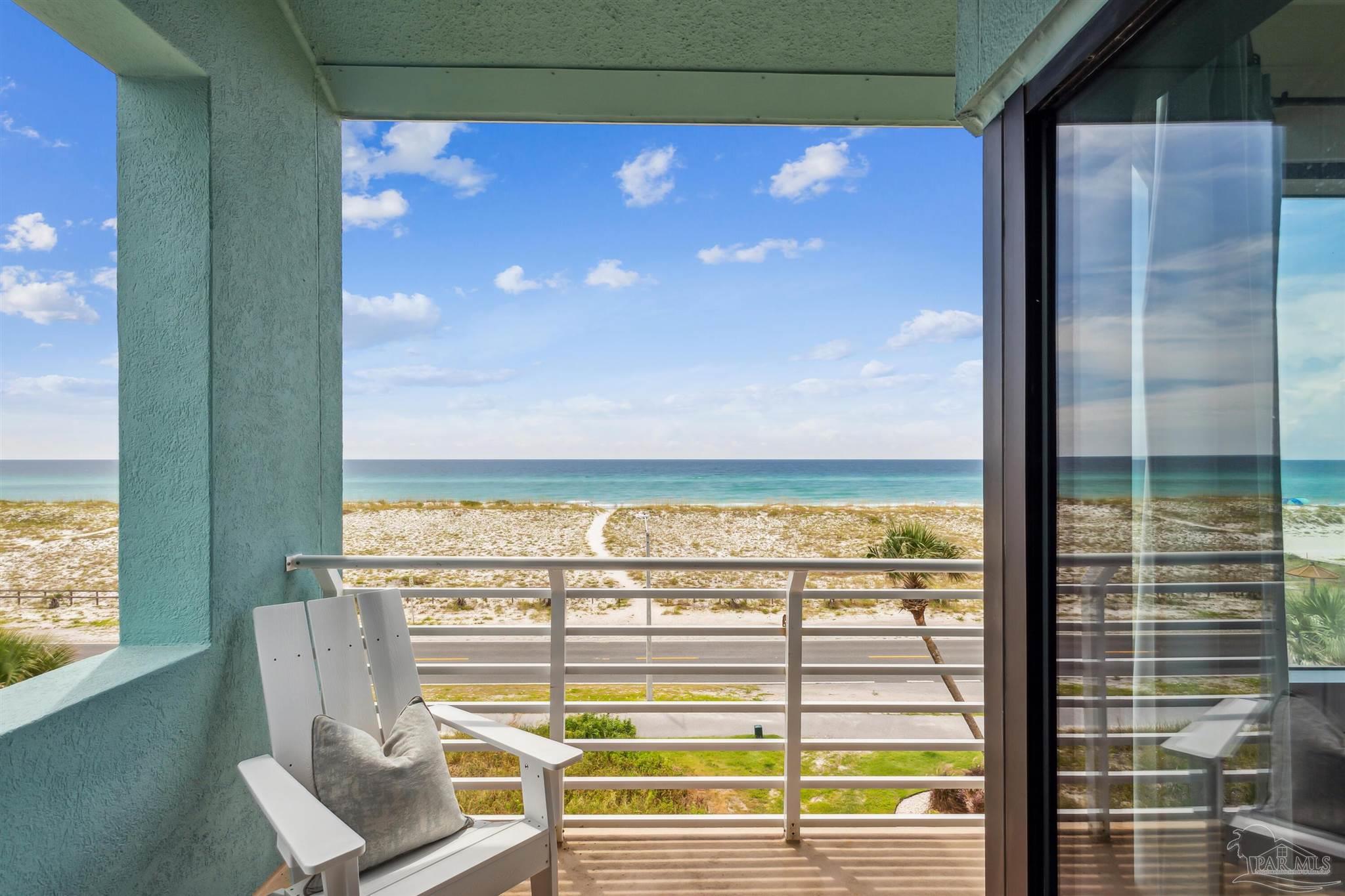 1390 Fort Pickens Road, Unit 229 Pensacola Beach, FL 32561 - Photo 12 of 47 a view of a balcony with table and chairs