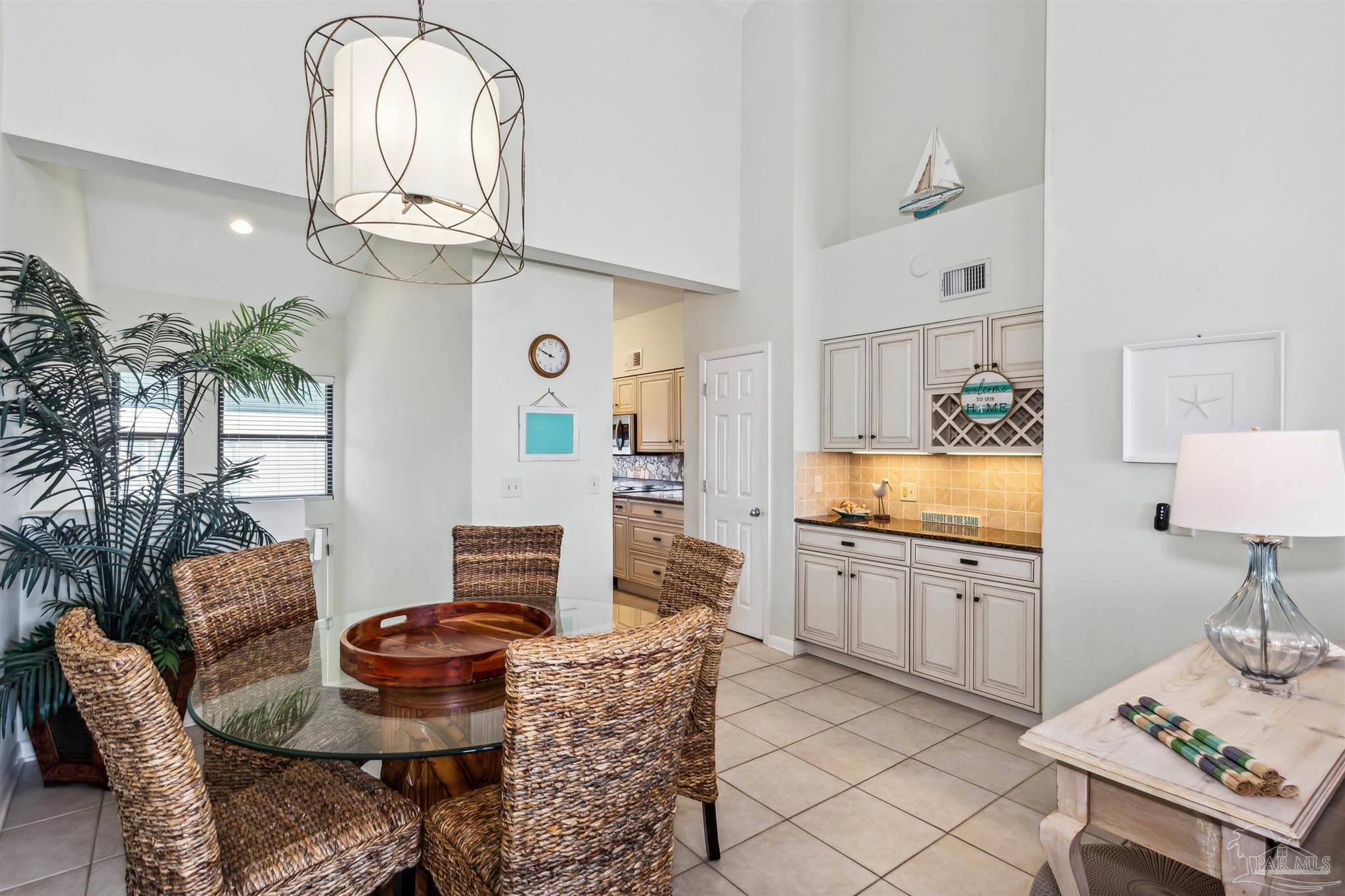 1390 Fort Pickens Road, Unit 229 Pensacola Beach, FL 32561 - Photo 13 of 47 a living room with furniture and a chandelier