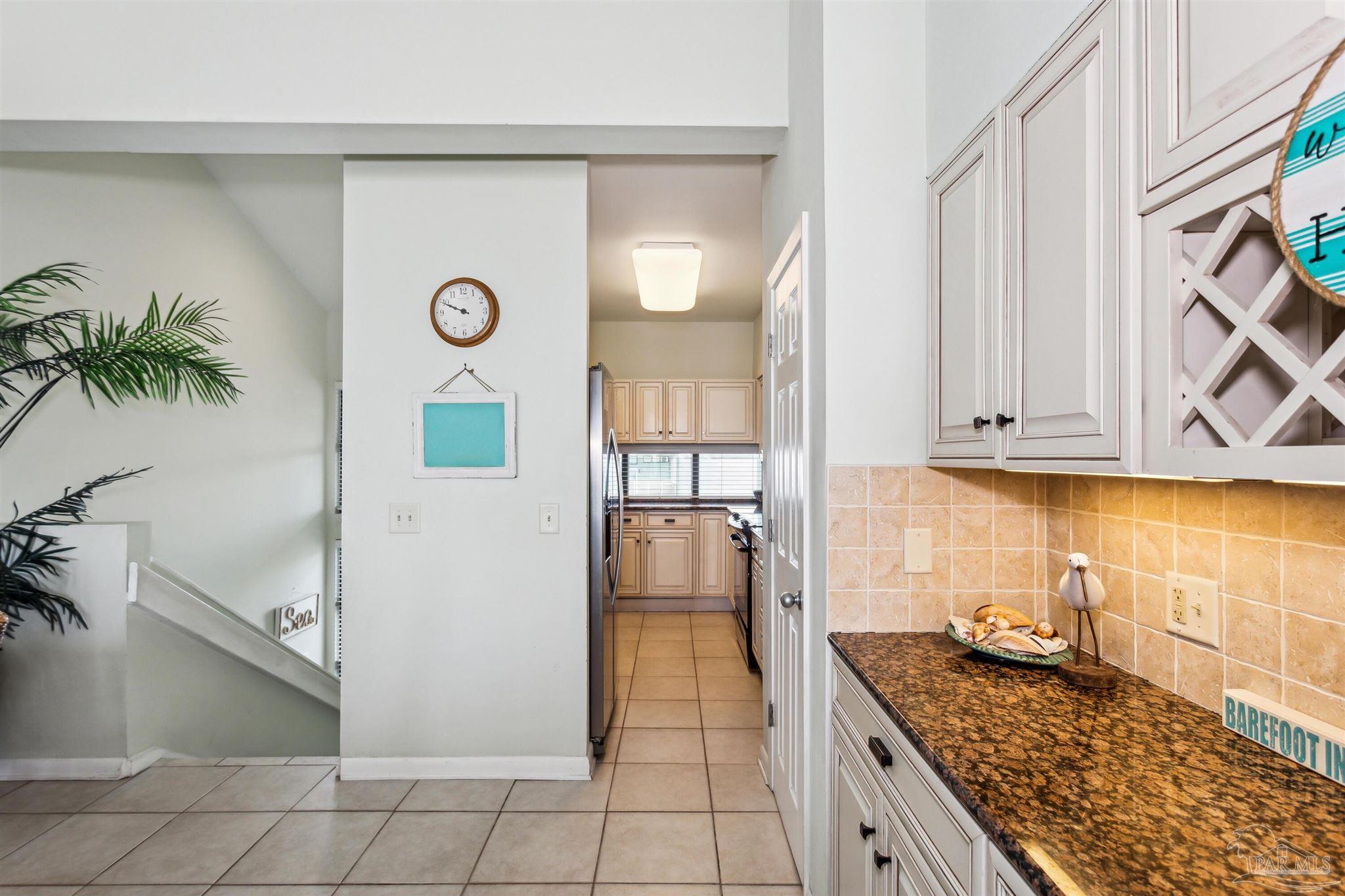1390 Fort Pickens Road, Unit 229 Pensacola Beach, FL 32561 - Photo 14 of 47 a kitchen with stainless steel appliances granite countertop a refrigerator and a stove