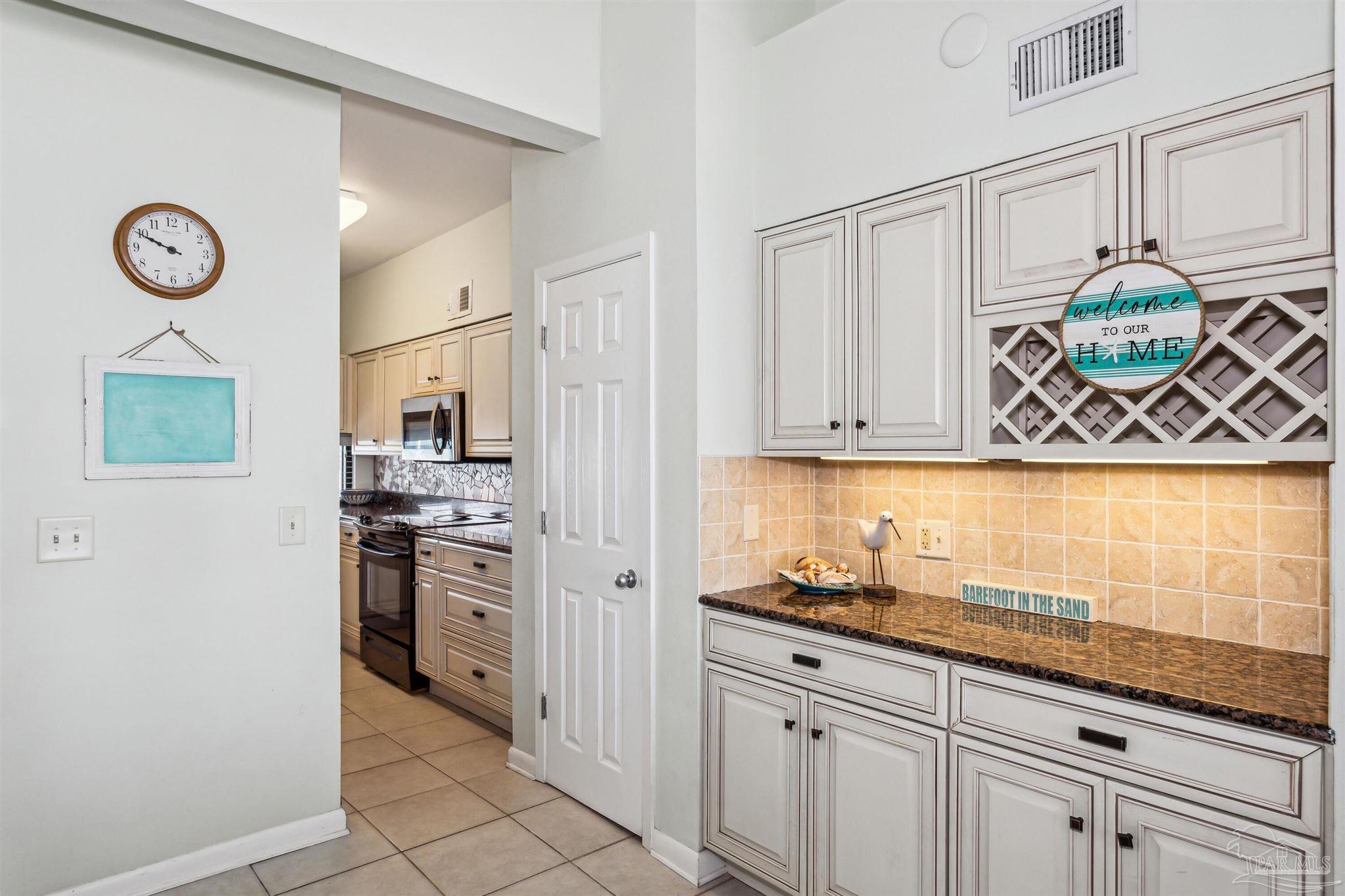 1390 Fort Pickens Road, Unit 229 Pensacola Beach, FL 32561 - Photo 15 of 47 a kitchen with stainless steel appliances granite countertop a sink a stove and a refrigerator
