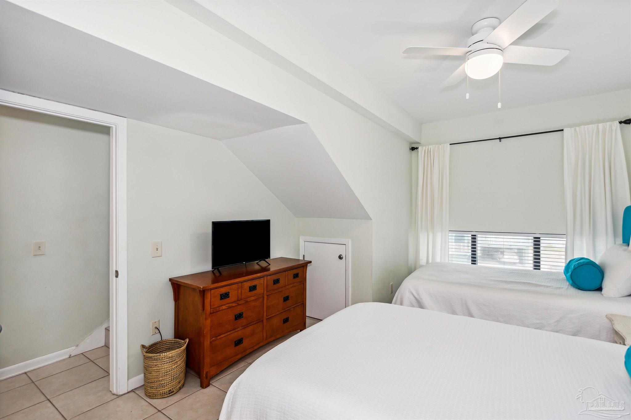 1390 Fort Pickens Road, Unit 229 Pensacola Beach, FL 32561 - Photo 26 of 47 a bedroom with a bed tv and a window