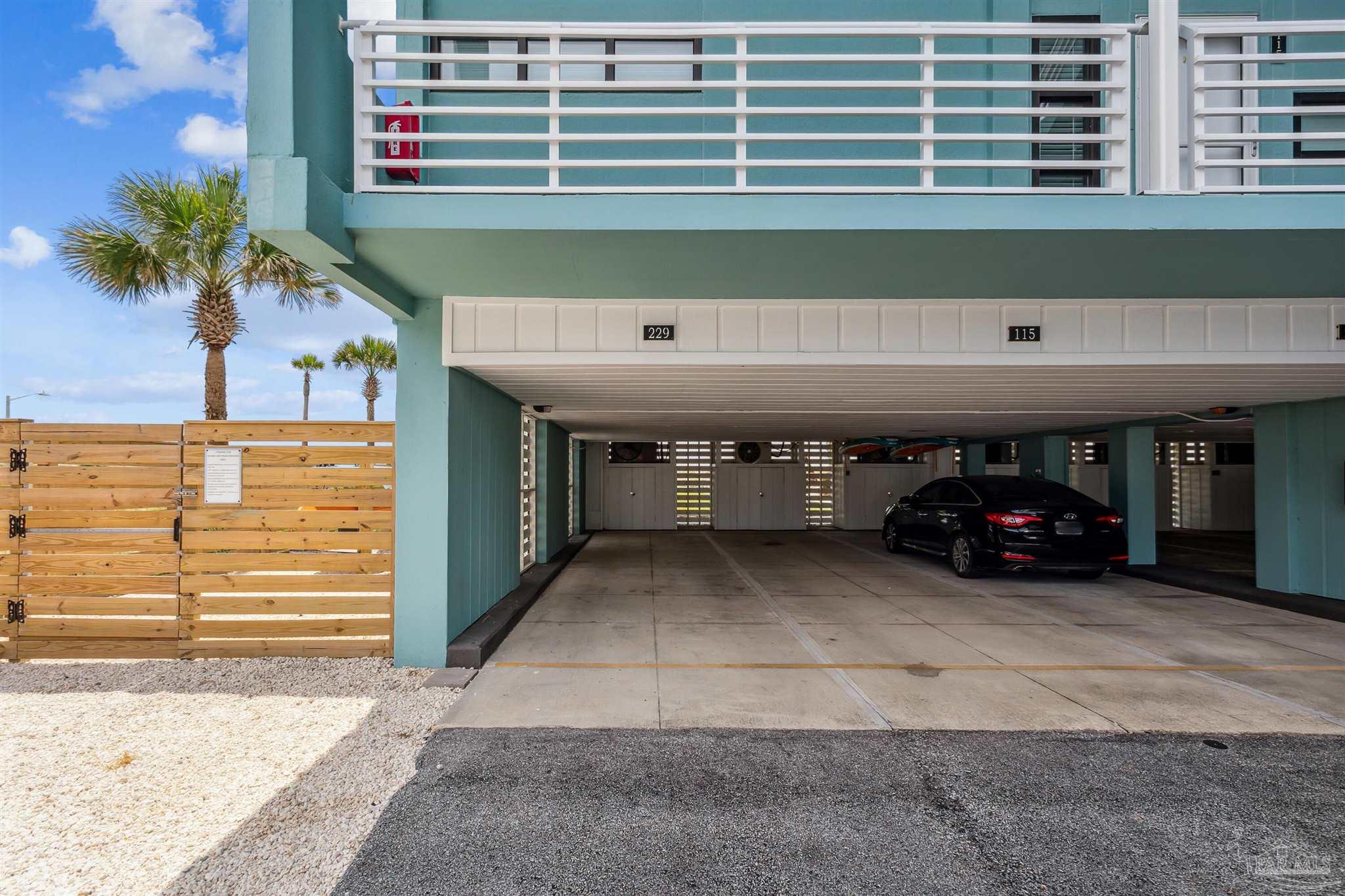 1390 Fort Pickens Road, Unit 229 Pensacola Beach, FL 32561 - Photo 29 of 47 a view of a car garage with a car parked