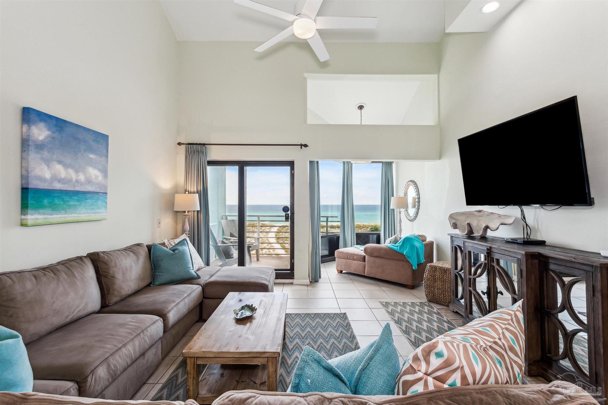 1390 Fort Pickens Road, Unit 229 Pensacola Beach, FL 32561 - Photo 3 of 47 a living room with furniture and a flat screen tv