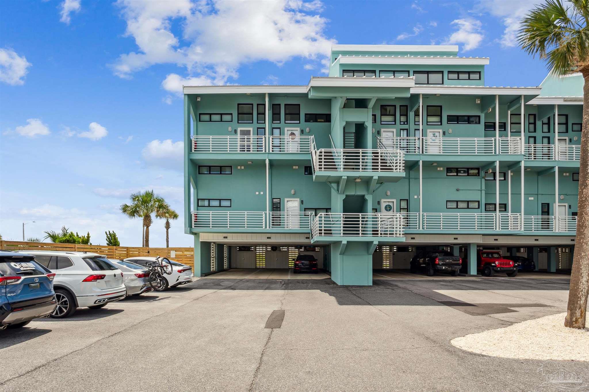 1390 Fort Pickens Road, Unit 229 Pensacola Beach, FL 32561 - Photo 31 of 47 a view of a cars park in front of a building