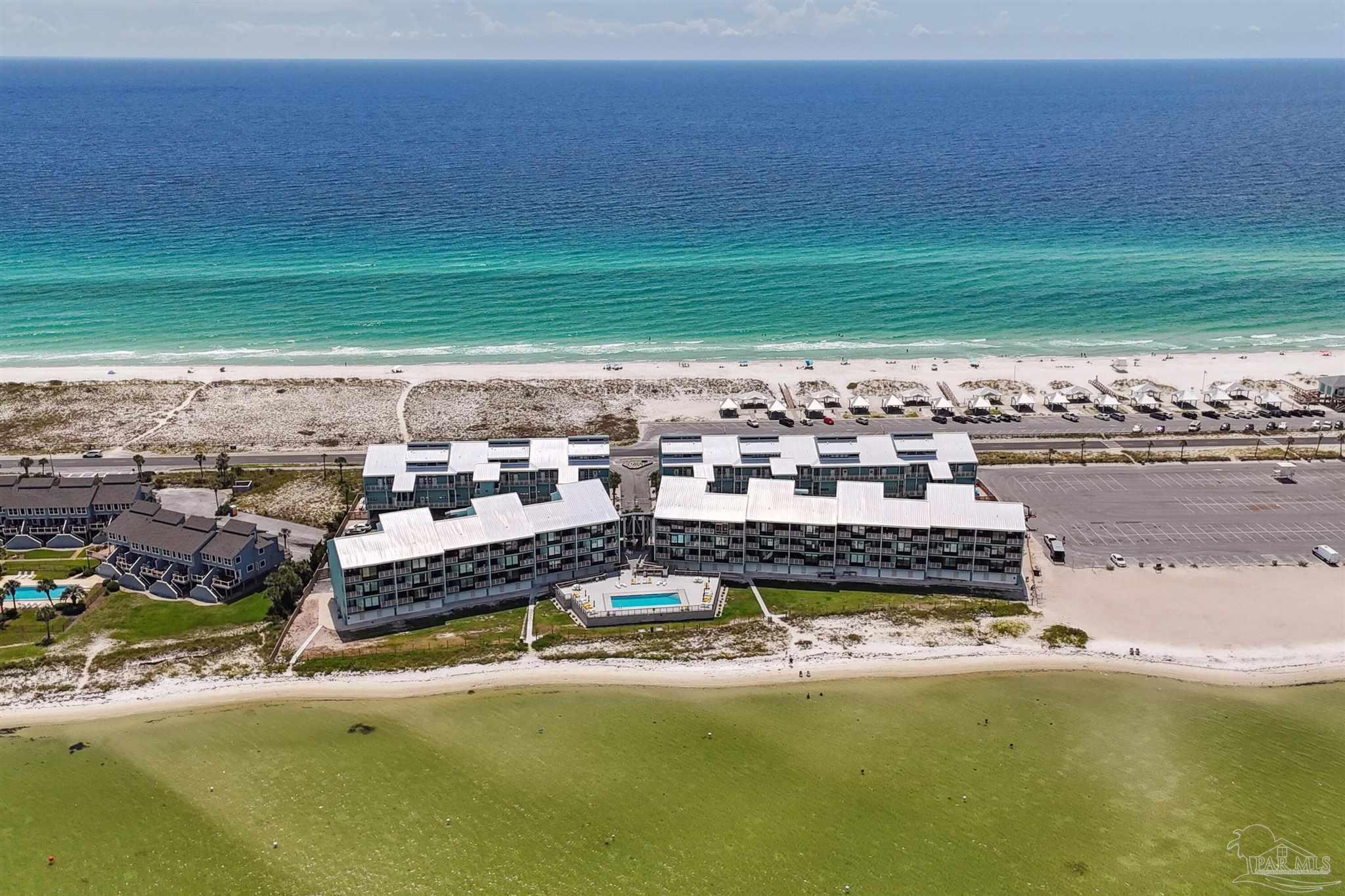 1390 Fort Pickens Road, Unit 229 Pensacola Beach, FL 32561 - Photo 38 of 47 a view of a lake with a big yard