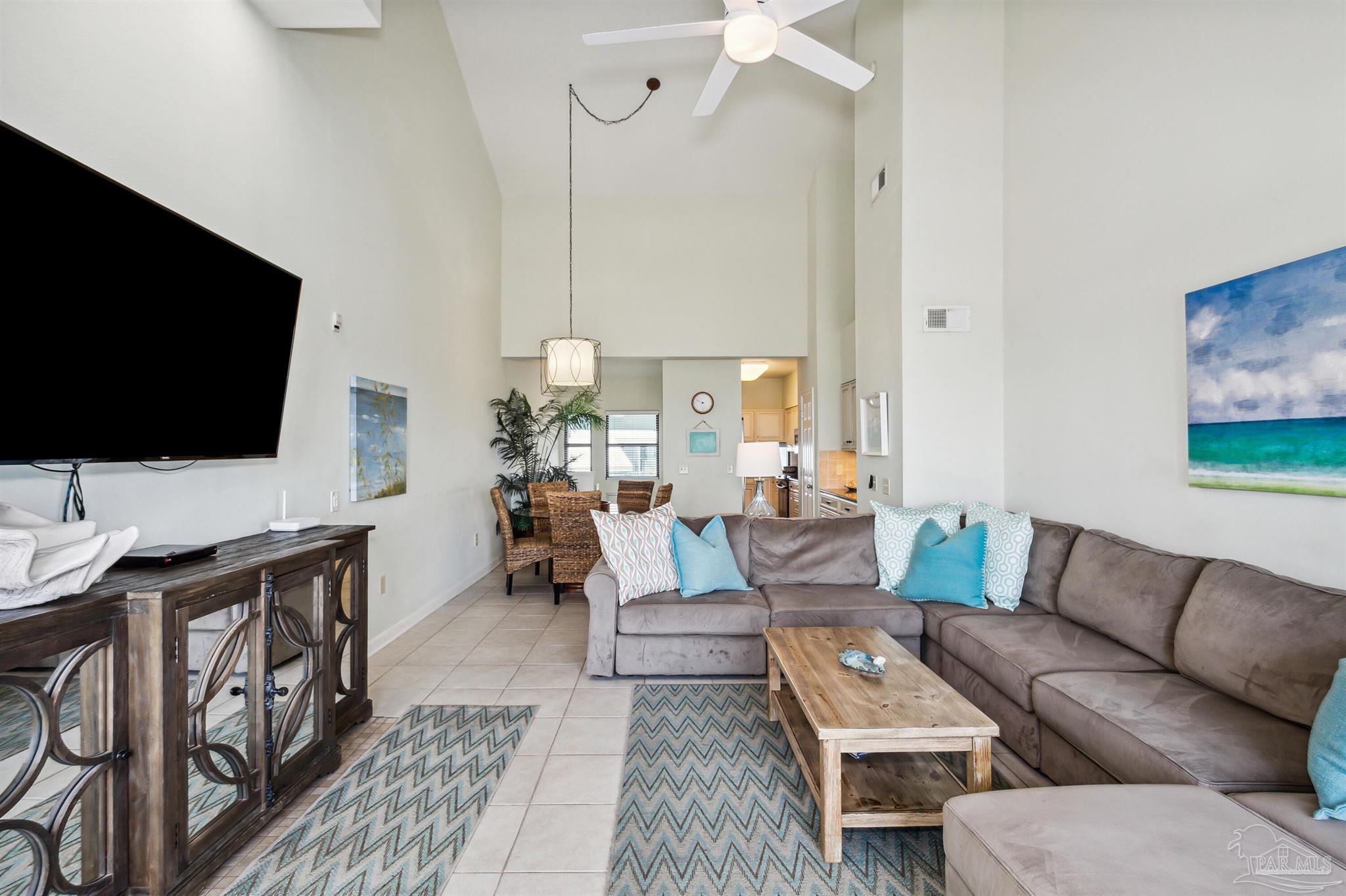 1390 Fort Pickens Road, Unit 229 Pensacola Beach, FL 32561 - Photo 8 of 47 a living room with furniture and a flat screen tv